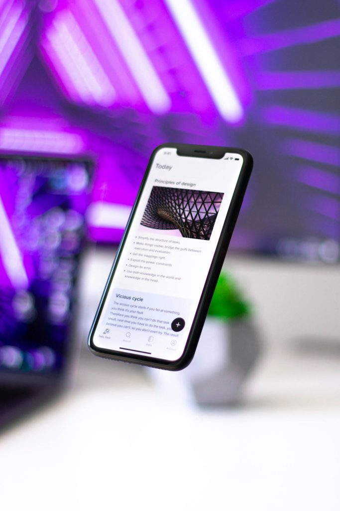 Floating iPhone XR with the Walling App open.