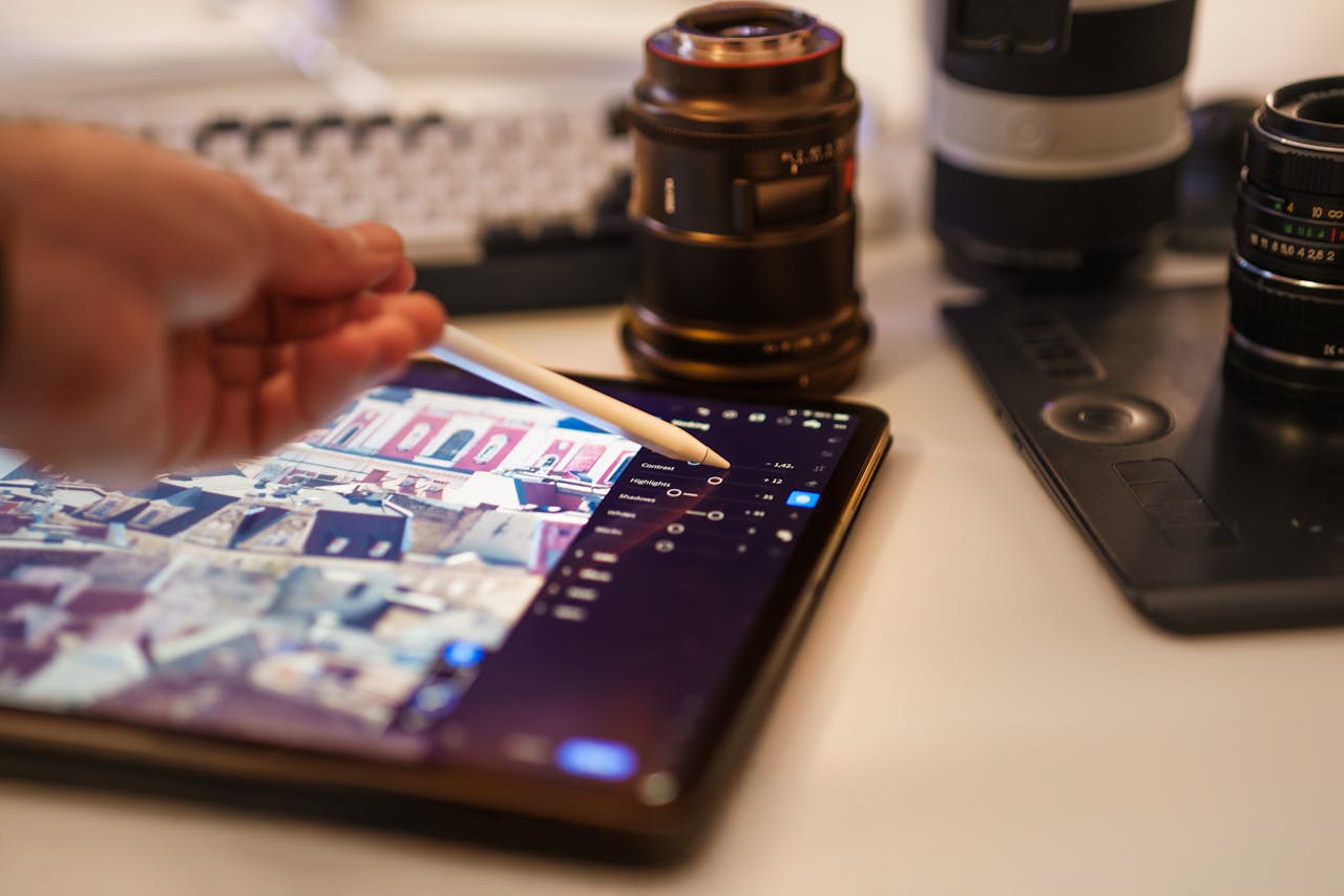 Mastering the First Impression: Your intriguing post title goes here A detailed view of a professional photography editing setup with tablet and lenses.